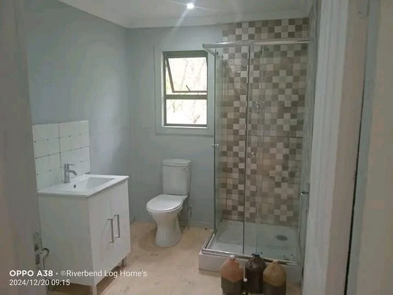 Bathroom interior with shower, basin and window