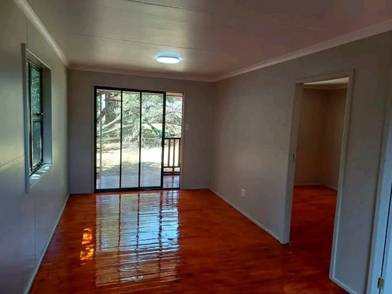 Open plan living area with wooden flooring