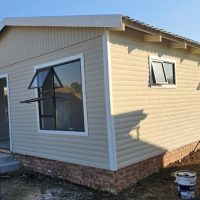 Nutec home with bay windows and high foundation