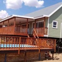 Log cabin with large timber deck and stairs