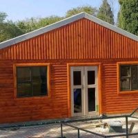Log cabin with stained wood exterior and double doors