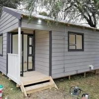 Small Nutec Wendy house painted grey with steps
