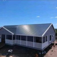Nutec house on elevated foundation with railing and veranda