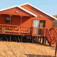 Log cabin with tiled roof and wooden deck