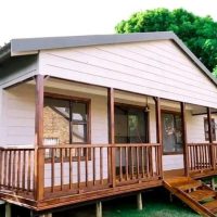 Nutec home with wooden deck and covered veranda