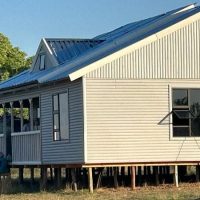 Nutec home with pitched roof and shaded front deck