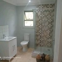 Bathroom interior with shower, basin and window